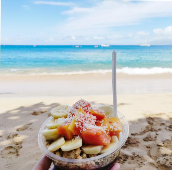 Acai bowl with papaya, banana and coconut on an Oahu beach