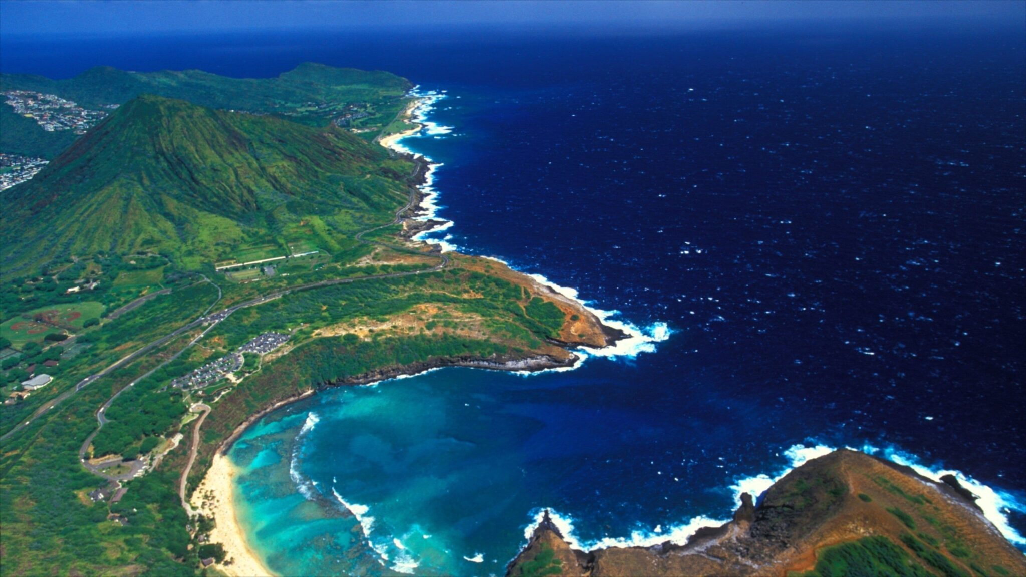 Aerial view of Hanauma Bay and Koko Head, with the reef showing through turquoise water