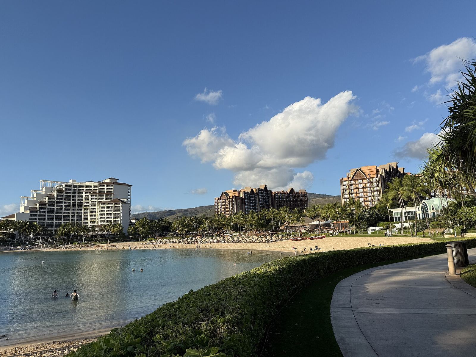 A Ko Olina lagoon beach with the Four Seasons at left and Aulani's towers behind
