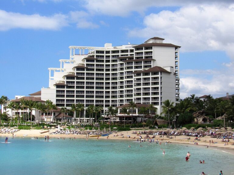 Swimmers and paddleboarders in the lagoon in front of the Four Seasons Oahu