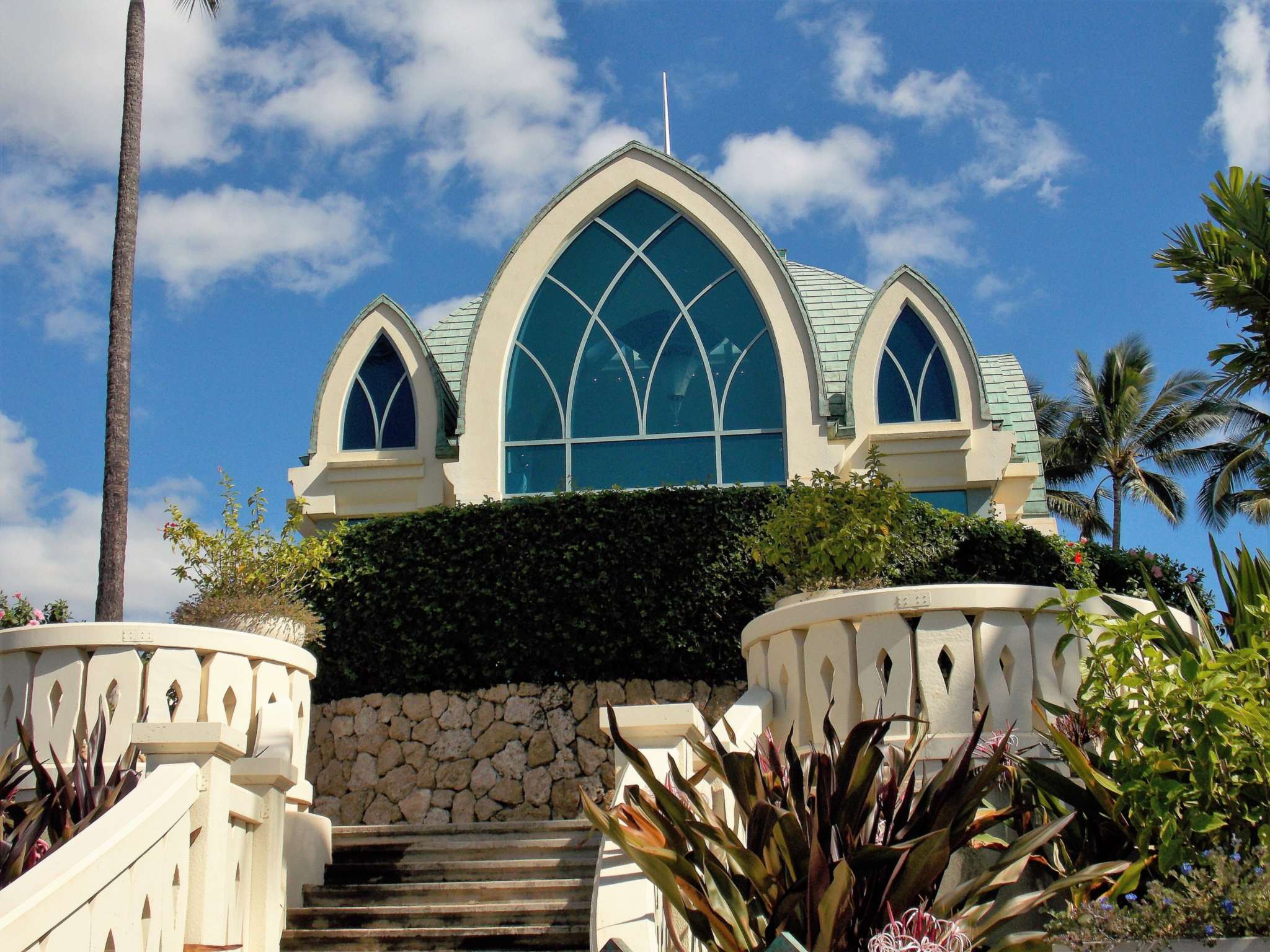 Ko Olina Chapel, a wedding chapel with tall arched blue windows, at the top of a stone stairway at Ko Olina on Oahu
