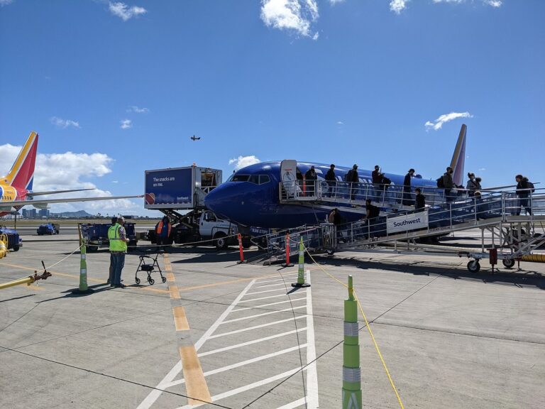 Passengers walking down airstairs from a Southwest plane on the Honolulu airport ramp