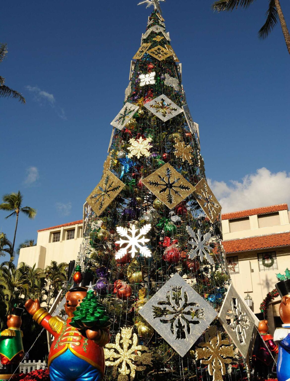 A decorated Christmas tree with toy soldier figures and red poinsettias at Honolulu City Lights