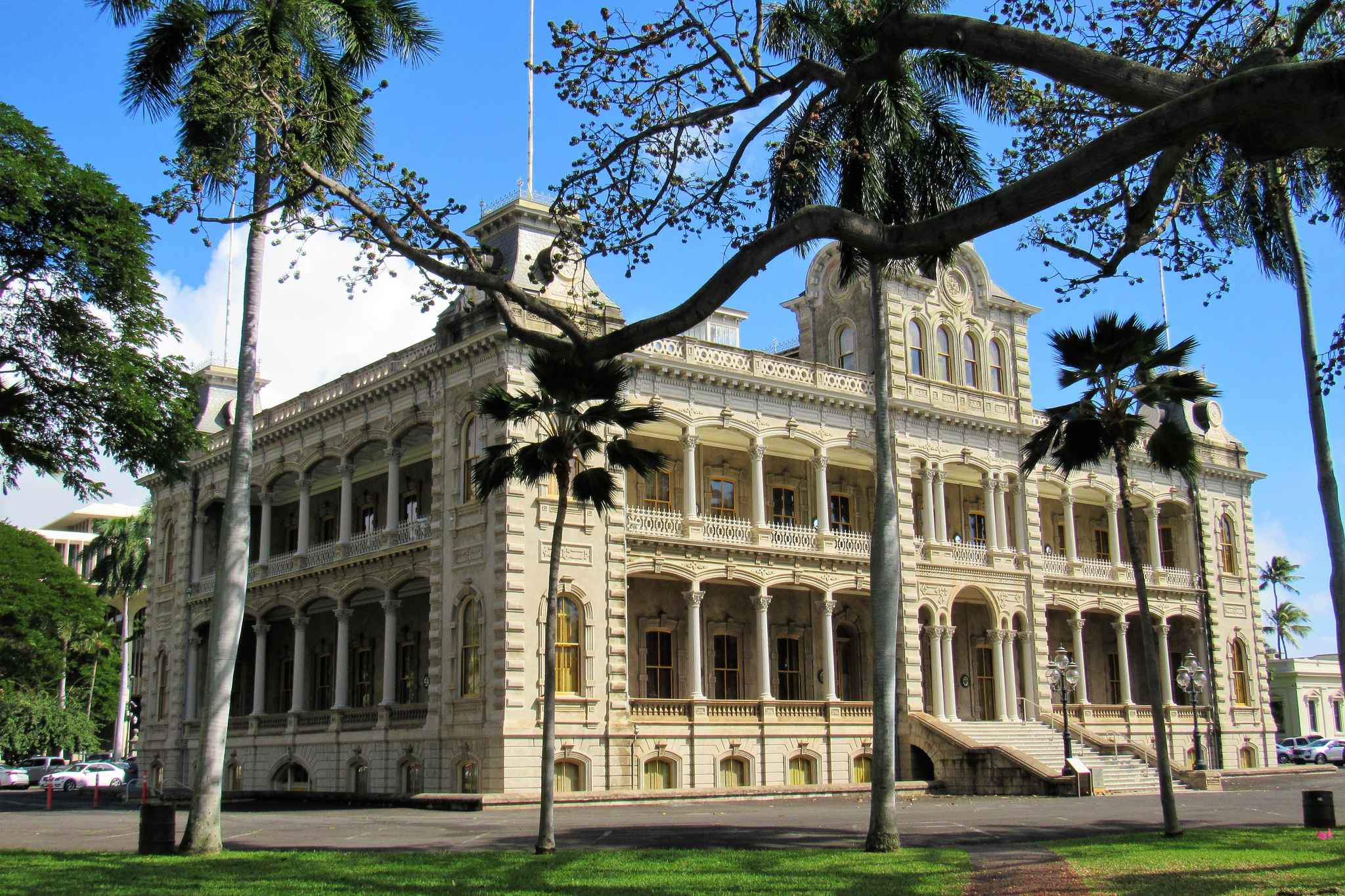 ʻIolani Palace in downtown Honolulu, the restored home of the Hawaiian Kingdom's last monarchs, framed by palms and a spreading tree
