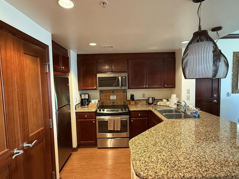 A villa kitchen with a full range, microwave and refrigerator