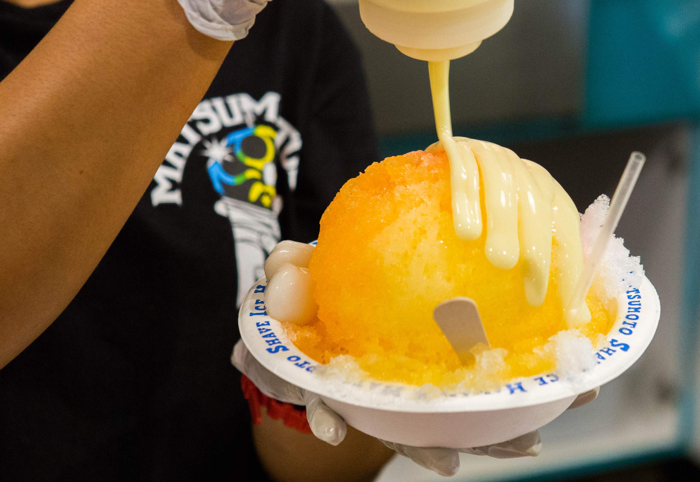 Condensed milk poured over a shave ice at Matsumoto Shave Ice in Haleiwa