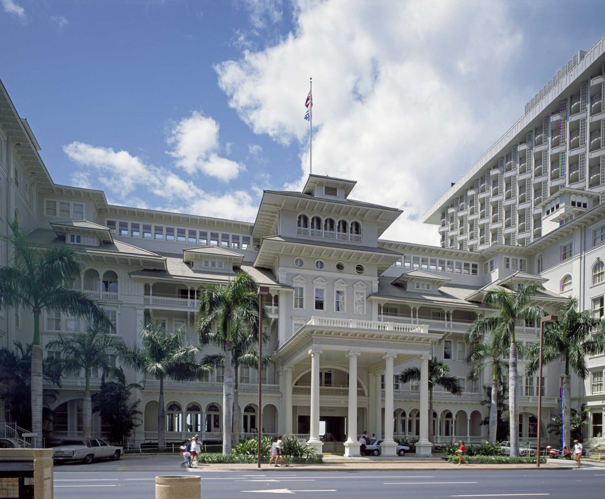 The white colonial facade of the Moana Surfrider on Kalakaua Avenue