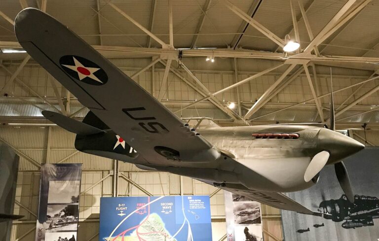 A World War II fighter plane suspended inside a hangar at the Pearl Harbor Aviation Museum