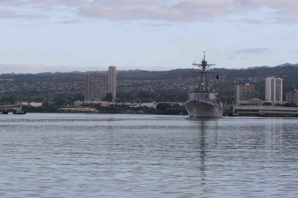A Navy destroyer with sailors lining the rails in Pearl Harbor on National Pearl Harbor Remembrance Day, December 7, 2015