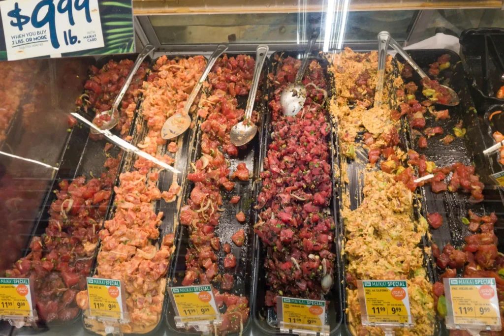 Trays of assorted poke in a Hawaii poke case
