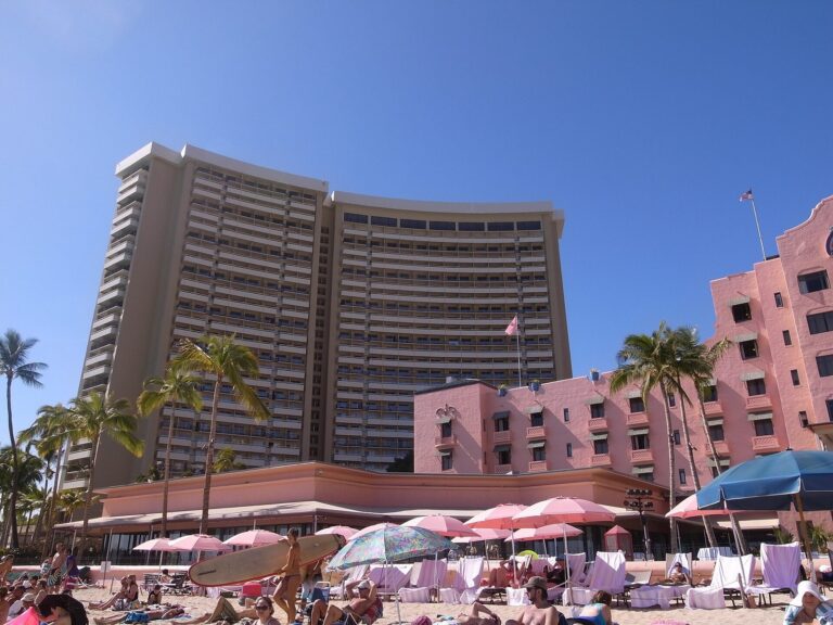 The Sheraton Waikiki tower beside the pink Royal Hawaiian, seen from the beach