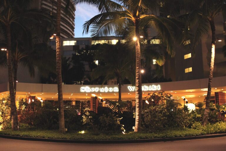 The Sheraton Waikiki entrance and sign lit at night