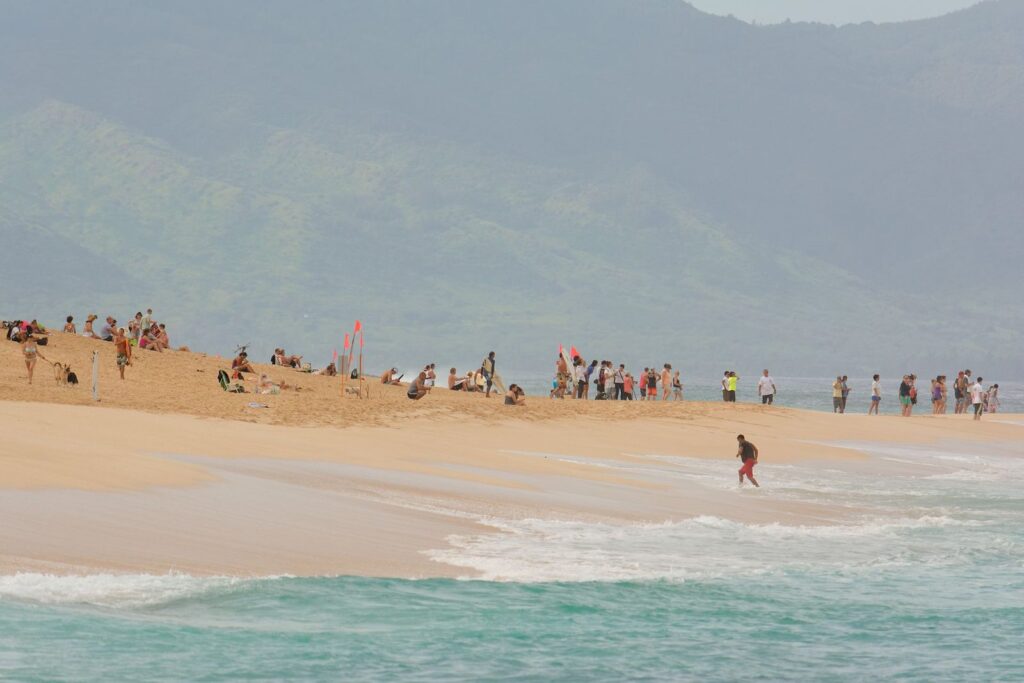 Spectators on the beach berm at Ehukai Beach Park, the viewing spot for the Banzai Pipeline