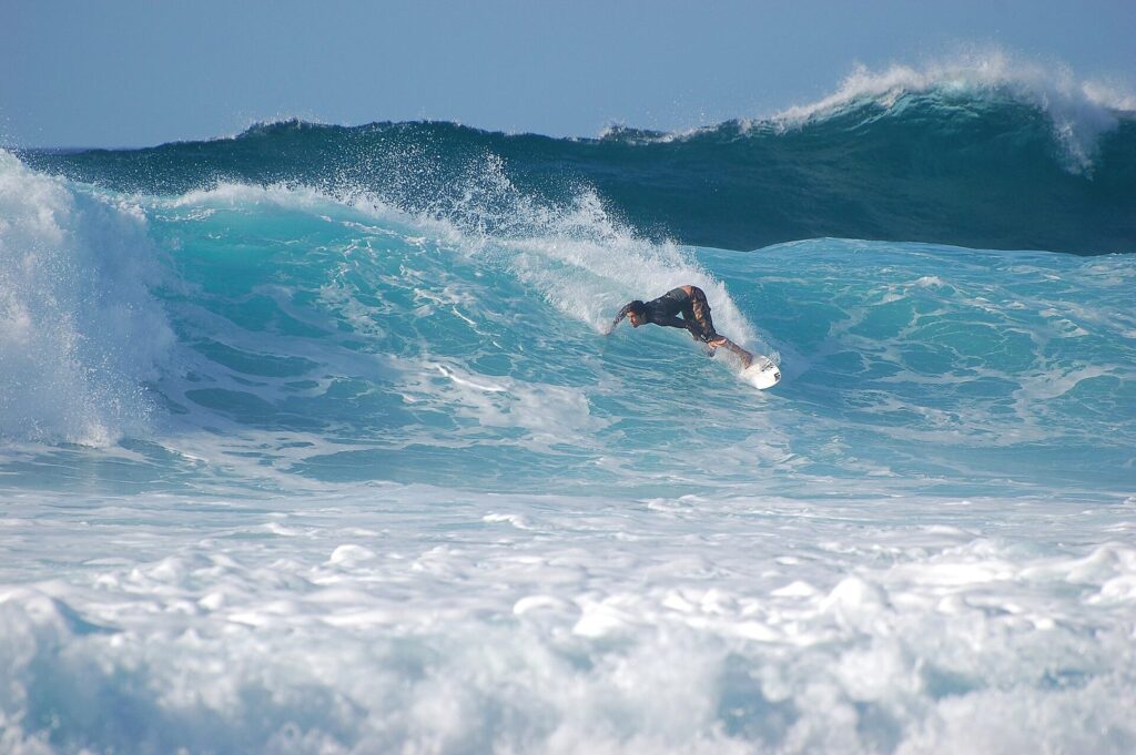 A surfer riding a winter wave at the Banzai Pipeline on Oahu's North Shore