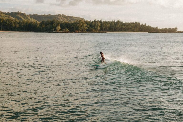 A surfer riding a wave at Turtle Bay on the North Shore