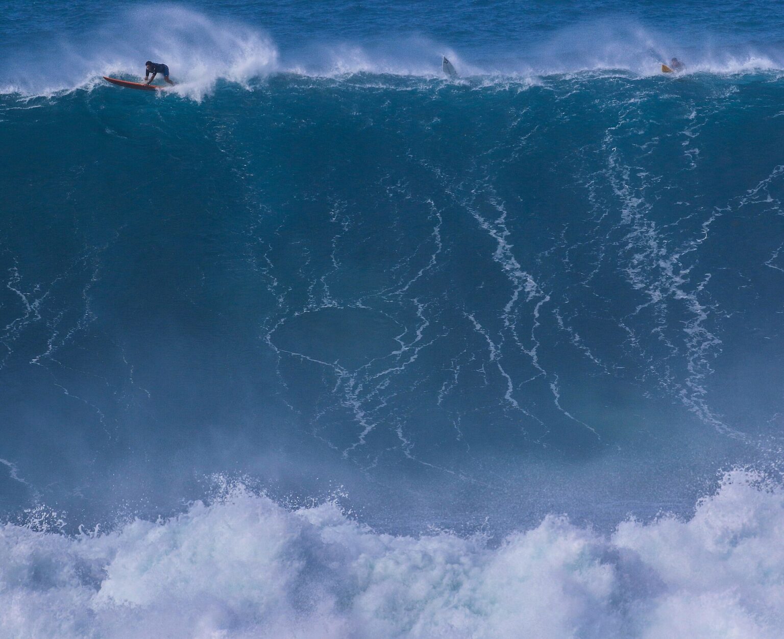 A surfer on a giant winter wave at Waimea Bay on Oahu's North Shore