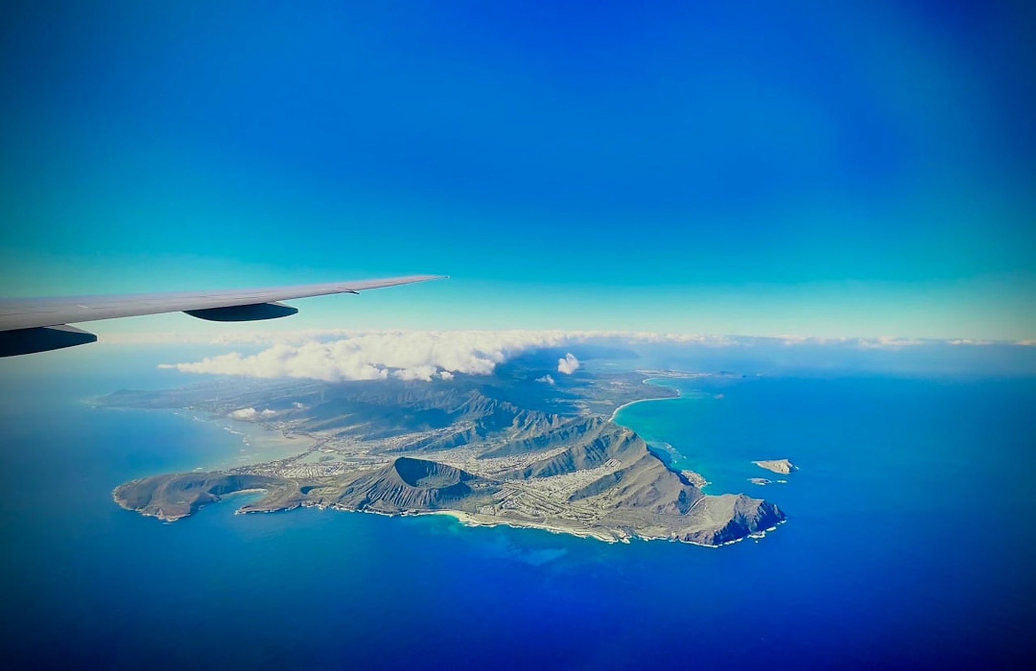 Aerial view from an airplane window of Oahu's southeast shore, Koko Crater and Hanauma Bay, on approach to Honolulu
