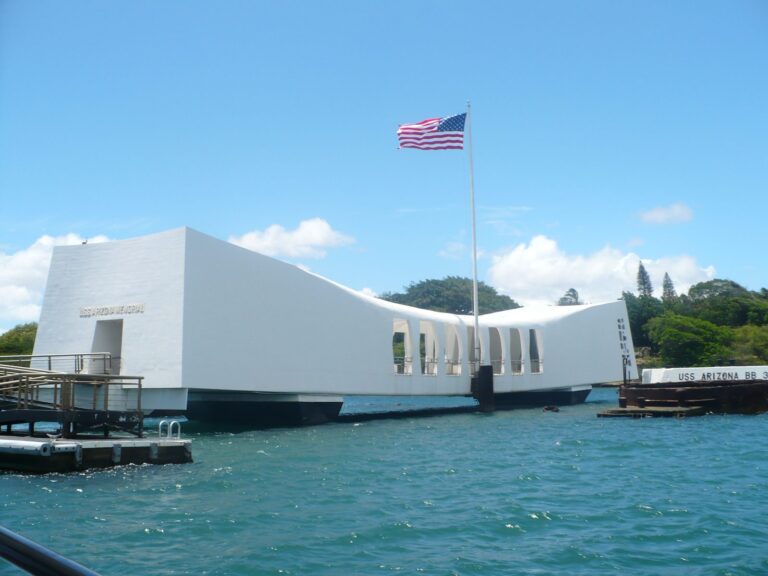 The white USS Arizona Memorial and its flag seen from the Navy shuttle boat in Pearl Harbor