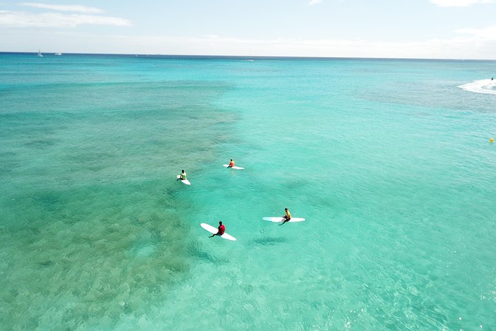 A beginner surf lesson in the shallow waves off Waikiki Beach