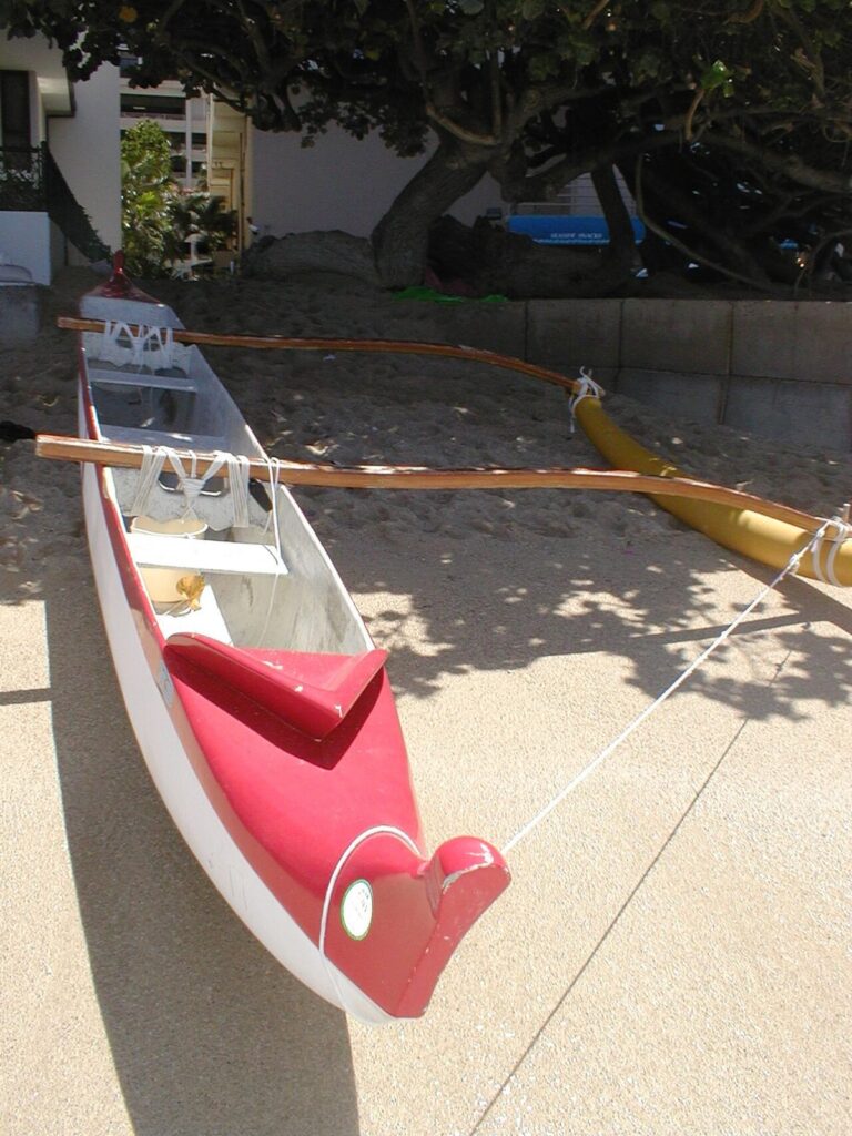 An outrigger canoe pulled up on the sand at Waikiki