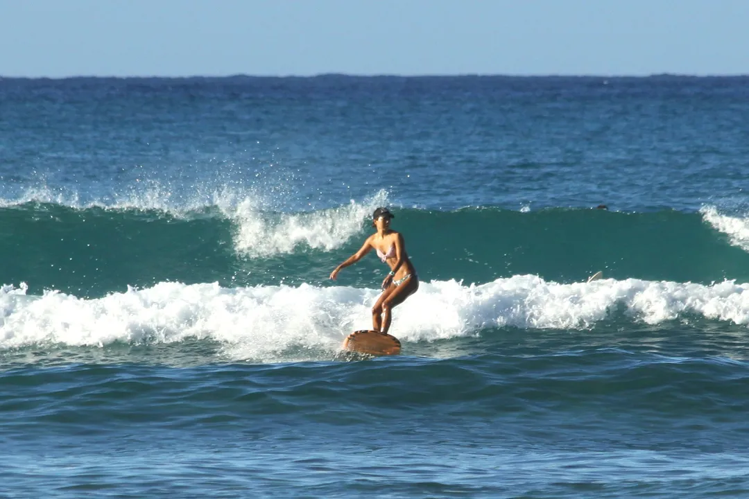 A surfer riding a wave off Waikiki