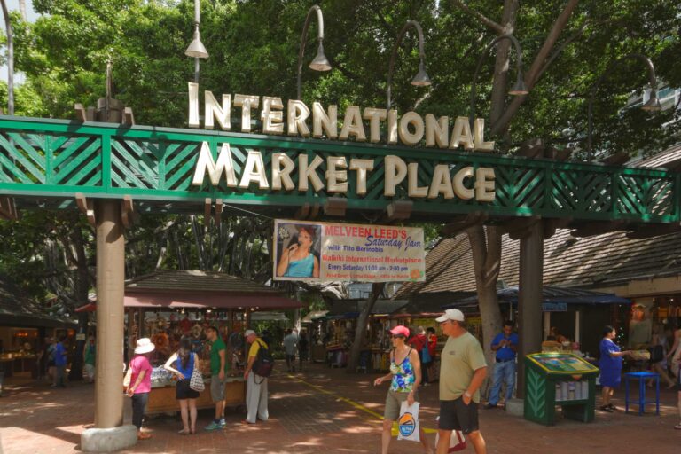 The International Market Place entrance sign over a crowded walkway in December 2013