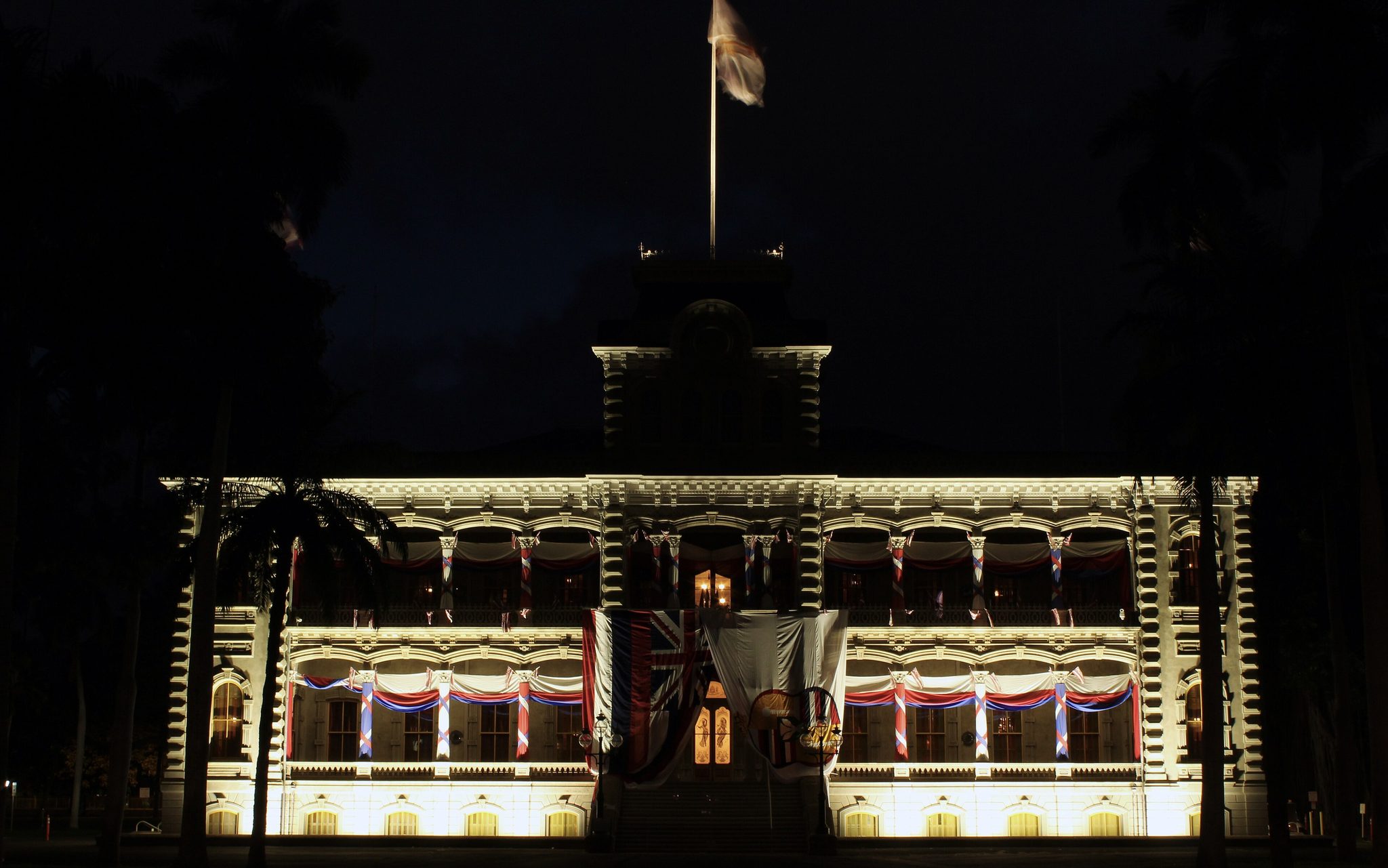 ʻIolani Palace lit up before dawn in downtown Honolulu, one of the haunted places on Oahu
