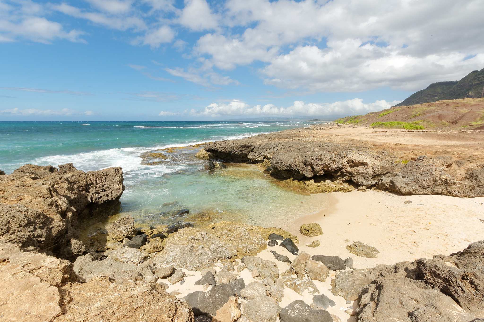 A rocky cove with turquoise water near the end of the road in the Mokulēʻia section of Kaʻena Point State Park