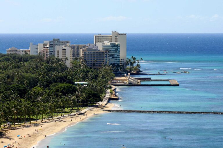 The Kapiʻolani Park shoreline from above, with Queen’s Surf, the park’s coconut grove and the Natatorium