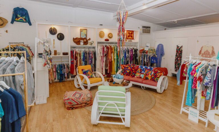 Racks of second-hand clothing and vintage furniture inside the Kōkua General Store