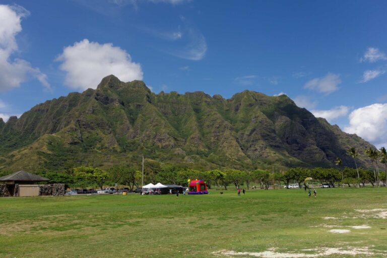 The Koʻolau ridge rising above the lawn at Kualoa Regional Park
