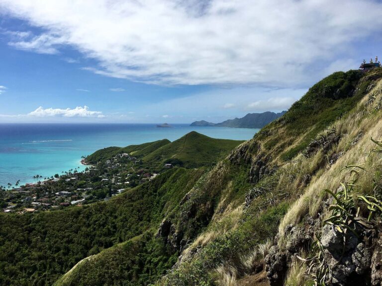 Hikers standing on a concrete pillbox at the top of Kaʻiwa Ridge above Lanikai