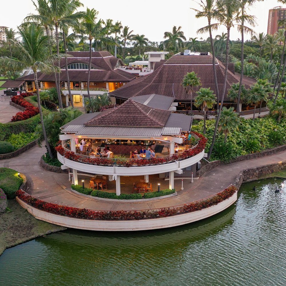Roy's Ko Olina, its round lanai over the golf course pond, with palms and the resort behind