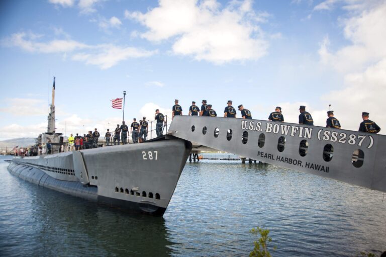 Sailors walking across the gangway onto the USS Bowfin at Pearl Harbor